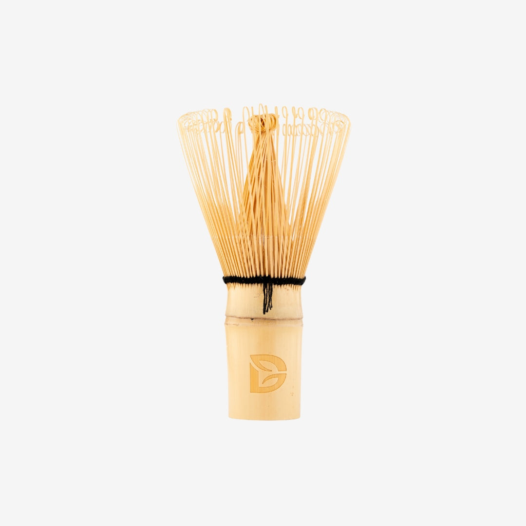 Traditional bamboo matcha whisk (chasen) with Dakys logo, designed for perfect ceremonial matcha preparation.