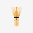 Traditional bamboo matcha whisk (chasen) with Dakys logo, designed for perfect ceremonial matcha preparation.