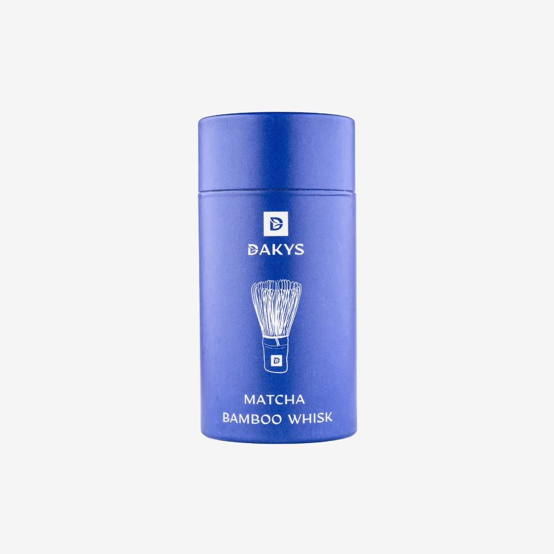 Blue Dakys tube containing a premium bamboo matcha whisk, designed for traditional matcha preparation.